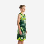 Side view of custom kids basketball uniforms showing neon lime V-neck binding, armhole trim, and continuous lightning graphic across jersey and shorts panels