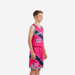 Hot pink custom kids basketball uniform front view showing arced team name across chest and front number 00 on matching shorts