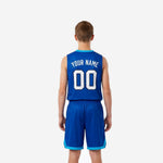 Right side view of custom kids basketball uniforms in royal blue showing the solid blue side panel shorts waistband and cyan accent trim