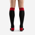 Detail view of custom black and red soccer socks ribbed red cuff and black body knit construction