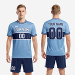 Custom light blue and navy 2-piece soccer uniform back view showing player name arc, back number placement, and full sublimation coverage