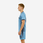 Custom light blue soccer uniform right side view showing full-dye sublimated navy stripe pattern across jersey and shorts