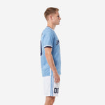 Side view of custom light blue soccer kit showing sleeve cuff detail and white shorts with blue stripe