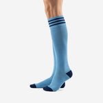 Custom light blue soccer socks showing navy blue toe panel and ribbed calf knit construction, angled view