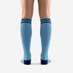 Light blue soccer socks with navy blue reinforced heel and toe panels showing cushioned footbed construction