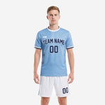 Custom light blue and white soccer uniform design with navy arched team name and number on front