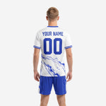 Close front detail of custom light blue soccer uniform showing Royal Blue marble sublimation and team name placement