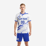 Custom light blue soccer uniform with Royal Blue marble sublimation print and matching shorts, front view on male model