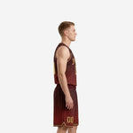 Custom maroon and gold basketball uniform full set on male model showing pinstripe jersey and matching shorts from the front
