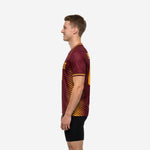 Custom Maroon mens soccer training jersey with Athletic Gold stripe panels and surname printed on back, right side view