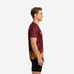Custom maroon soccer practice jersey showing botanical leaf sleeve texture and athletic gold gradient hem, left side view