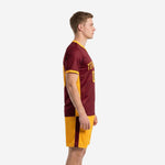 Custom maroon soccer uniform left side view showing Athletic Gold contrast side panel on jersey and maroon side stripe on Athletic Gold shorts