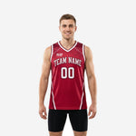 Custom maroon basketball jerseys with halftone dot fade shoulders, white V-neck trim, arced team name, and front number on male model - front and back view