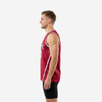 Side view of custom maroon basketball jersey showing white contrast side-panel stripes, halftone dot shoulder pattern, and tuck-in hem length on male model