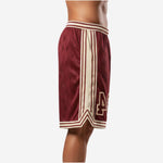 Side view of custom maroon basketball shorts showing full-length cream side panel with double maroon border stripes and V-point hem detail