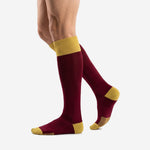 Custom maroon soccer socks with Athletic Gold cuff, angled side view showing full calf length on male model