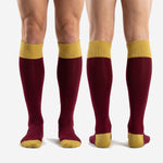 Full-length view of custom maroon soccer socks with Athletic Gold contrast zones on male model