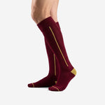 Custom maroon soccer socks with Athletic Gold side stripe and cushioned footbed, right side view on male model