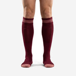 Custom maroon soccer socks with rose-pink ribbed cuff band, front view on adult male model