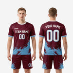 Full custom maroon matchday soccer kit showing complete jersey and shorts set with sky blue and white trim