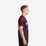 Side view of custom maroon navy blue men's soccer team jerseys showing continuous vertical stripe and sleeve cuff trim detail