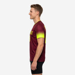Custom maroon soccer training jersey with neon yellow cuff and back number visible, rear side view on adult male model