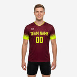 Custom maroon soccer training jersey with neon yellow gradient sleeves and team name printed on chest, front view on adult male model