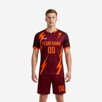 Custom maroon and orange soccer uniform front view showing lightning-bolt sublimation print on jersey and matching shorts