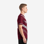 Custom maroon soccer jersey left side view showing silver geometric panel lines running from shoulder to hem