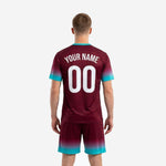 Close detail of custom maroon soccer jersey with teal V-neckline trim and sublimated gradient sleeve