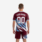 Custom maroon soccer kit V-neck jersey detail with sky blue collar trim and white star print across upper chest