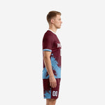 Maroon soccer uniform set side view showing sky blue brush-stroke pattern on jersey and matching shorts