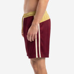 Custom maroon soccer shorts showing ivory double stripe from hip to straight hem, right side view on male model