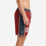 Custom maroon soccer shorts side view showing full charcoal panel with diagonal texture pattern and white piping stripe