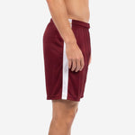 Maroon soccer shorts with white side panel running from hip to hem, left side view showing panel construction on adult male model