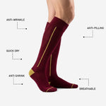 Close-up of maroon soccer socks calf panel showing Athletic Gold pinstripe detail and ribbed knit texture