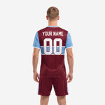 Close detail of custom maroon soccer team kit jersey with sky blue horizontal stripes and white V-neck trim