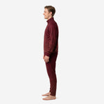 Custom maroon soccer tracksuit side profile highlighting dot-burst geometric knit pattern and athletic cut tapered pants