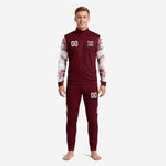 Custom maroon soccer tracksuit with white marble-splash sleeve panels and matching tapered pants, front view on male model