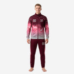 Custom maroon soccer tracksuit with galaxy gradient full-dye sublimation print, front view on male model showing chest logo and player number zones