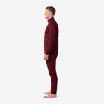 Clean side view of men's custom maroon soccer tracksuit set showing tapered pant cut and stand collar jacket