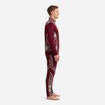 Maroon soccer tracksuit side view displaying silver geometric hex panels across shoulder and lower pant leg on adult male model