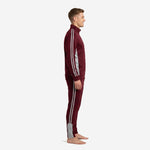 Custom maroon soccer tracksuit side view showing silver-grey contrast side panel and double stripe running from shoulder to cuff and hip to ankle