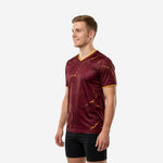 Custom maroon soccer training jersey showing Athletic Gold marble pattern and gold sleeve cuff trim, right side view