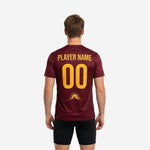 Close detail of athletic gold gradient hem and treeline silhouette on custom maroon soccer practice jersey