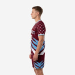 Custom maroon soccer uniform back-side view displaying white star print on shoulders and sky blue slash detailing on shorts