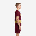 Custom maroon soccer uniforms side view showing sublimated Athletic Gold stripe and cream sleeve cuff trim on men's kit