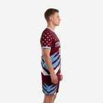 Custom maroon soccer uniform side view showing sky blue diagonal slash pattern across jersey and matching maroon shorts