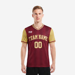 Custom red and black soccer jersey in maroon and Vegas Gold with arched team name and front number on male model front view