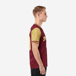 Men's custom red and black soccer jersey side view showing Vegas Gold contrast sleeves and double stripe cuff trim